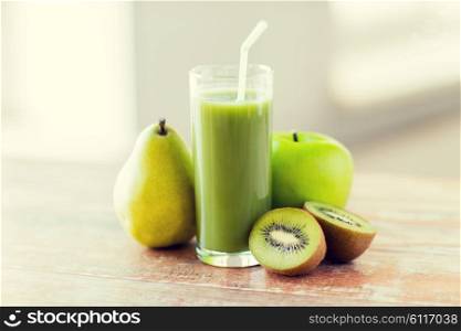 healthy eating, organic food and diet concept - close up of fresh green juice glass and fruits on table