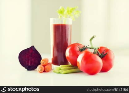 healthy eating, organic food and diet concept - close up of fresh juice glass and vegetables on table