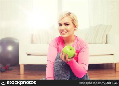 healthy eating, organic food, diet and people concept - happy woman eating green apple at home. happy woman eating green apple at home