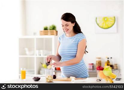 healthy eating, pregnancy and people concept - pregnant woman with knife putting fruits to blender cup at home kitchen. pregnant woman putting fruits to blender at home