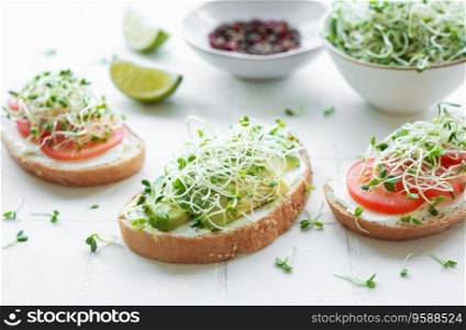 Healthy Eating. Sandwiches with tomatoes, avocado and fresh microgreens.