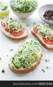 Healthy Eating. Sandwiches with tomatoes, avocado and fresh microgreens.