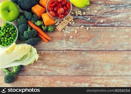 healthy eating, vegetarian food, advertisement and culinary concept - close up of ripe vegetables on wooden table