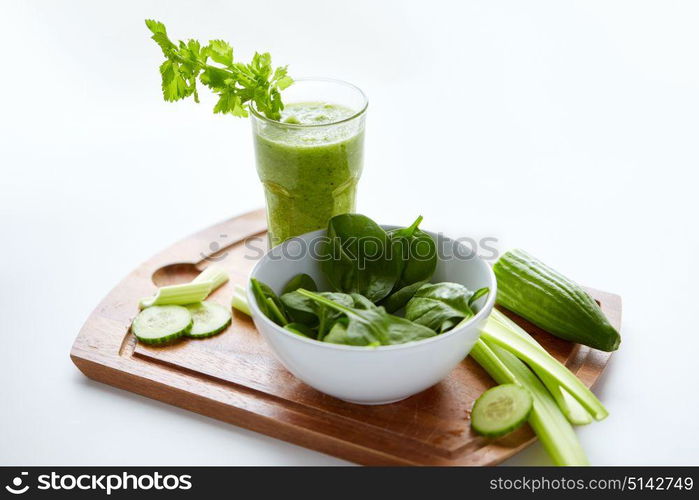 healthy eating, vegetarian food and diet concept - close up of glass with green juice, fruits and vegetables on table. close up of glass with green juice and vegetables