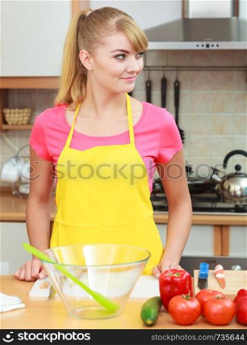 Healthy eating, vegetarian food, cooking, dieting and people concept. Woman in modern kitchen at home preparing fresh vegetables salad closeup