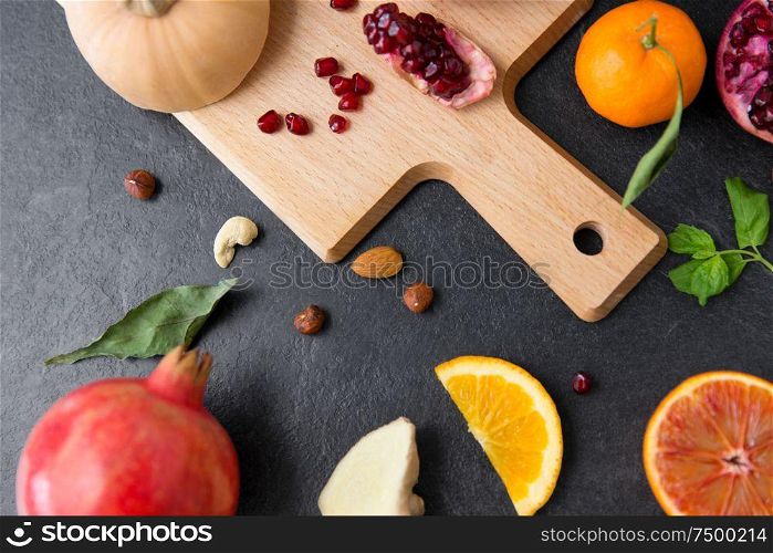 healthy eating, vegetarian food, diet and culinary concept - different vegetables and fruits on on slate table. different vegetables and fruits on on slate table