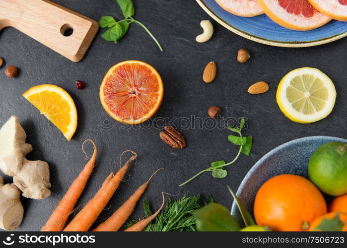 healthy eating, vegetarian food, diet and culinary concept - different vegetables and fruits on on slate table. different vegetables and fruits on on slate table