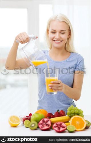 healthy eating, vegetarian food, diet, detox and people concept - smiling woman pouring fruit orange juice from jug to glass at home