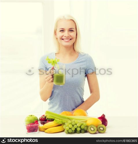 healthy eating, vegetarian food, diet, detox and people concept - smiling woman drinking green vegetable juice or shake from glass at home