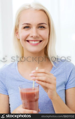 healthy eating, vegetarian food, dieting and people concept - smiling woman drinking juice or shake from glass at home