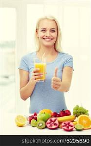 healthy eating, vegetarian food, dieting and people concept - smiling woman drinking fruit shake from glass at home showing thumbs up
