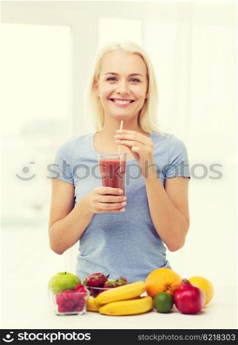 healthy eating, vegetarian food, dieting and people concept - smiling woman drinking fruit shake from glass at home