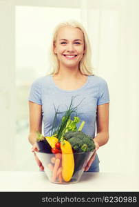 healthy eating, vegetarian food, dieting and people concept - smiling young woman with bowl of vegetables at home