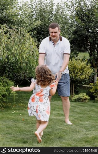 Healthy father and daughter playing together outdoors carefree happy fun smiling lifestyle. father&rsquo;s day.. Healthy father and daughter playing together outdoors carefree happy fun smiling lifestyle. father&rsquo;s day