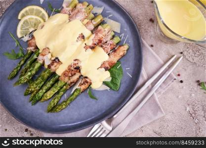 Healthy food - Asparagus wrapped with bacon and spices on a plate.. Healthy food - Asparagus wrapped with bacon and spices on a plate