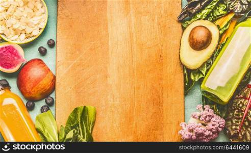 Healthy food background with beverage smoothie bottles , fruits and vegetables , top view, frame. Detox, dieting and clean eating concept