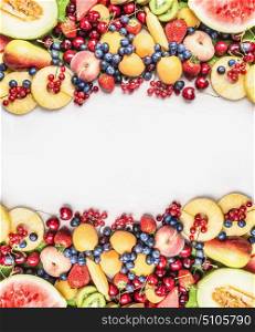 Healthy food background with various fruits on white wooden background, top view, copy space, frame