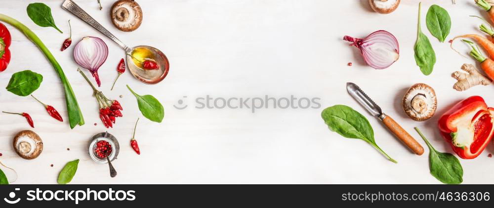 Healthy food background with various vegetables ingredients, spoon with oil and peeler, top view