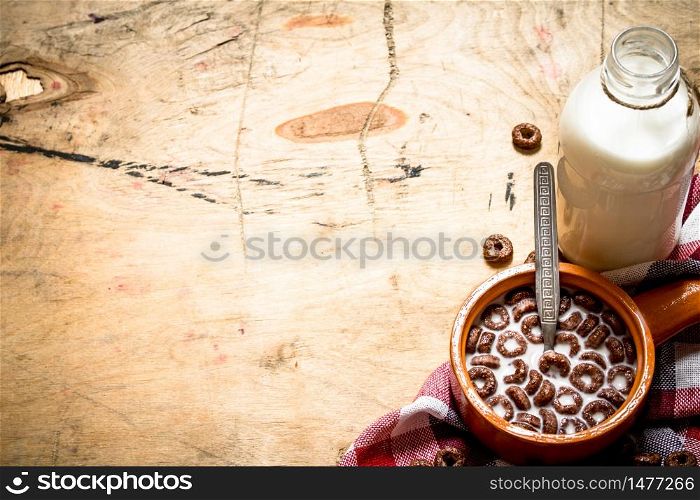 Healthy food. Chocolate cereal with milk. On wooden background.. Healthy food. Chocolate cereal with milk.