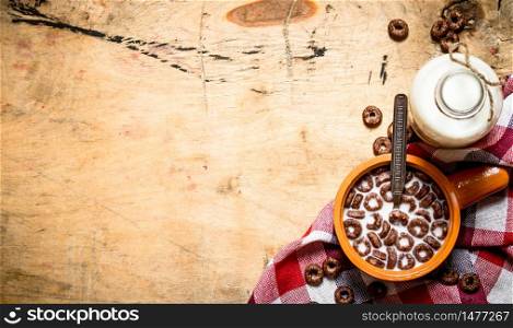 Healthy food. Chocolate cereal with milk. On wooden background.. Healthy food. Chocolate cereal with milk.