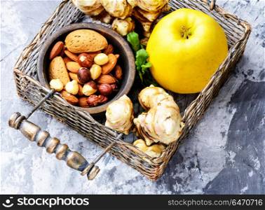 Healthy food composition. Healthy food concept with with Jerusalem artichoke, apple, nuts.Superfood