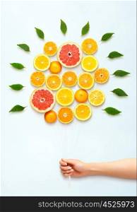 Healthy food concept and creative still life of bouquet made of fresh citrus fruits.