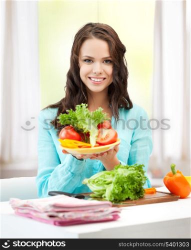 healthy food concept - beautiful woman in the kitchen with vegetables