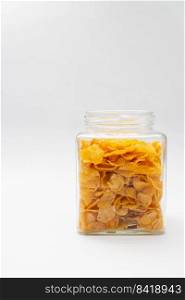 Healthy food concept, Cornflakes in glass jar to preparing for breakfast meal on white background.