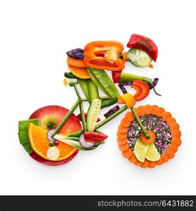 Healthy food concept of a cyclist riding a bike made of fresh vegetables and fruits, isolated on white.