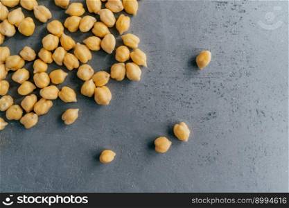 Healthy food concept. Protein nut seeds spill on grey background, copy space for text. Chickpea beans for tasty protein nutrition.