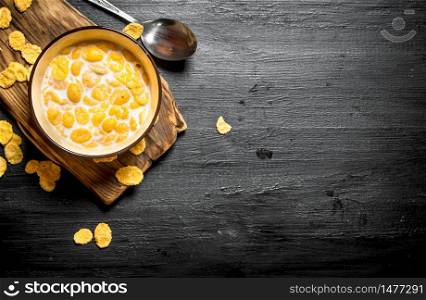 Healthy food. Cornflakes with milk on a wooden Board.. Cornflakes with milk on a wooden Board.