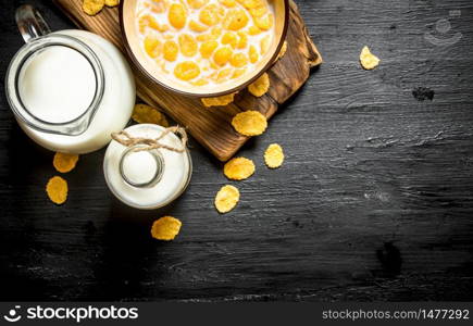 Healthy food. Cornflakes with milk on a wooden Board.. Cornflakes with milk on a wooden Board.