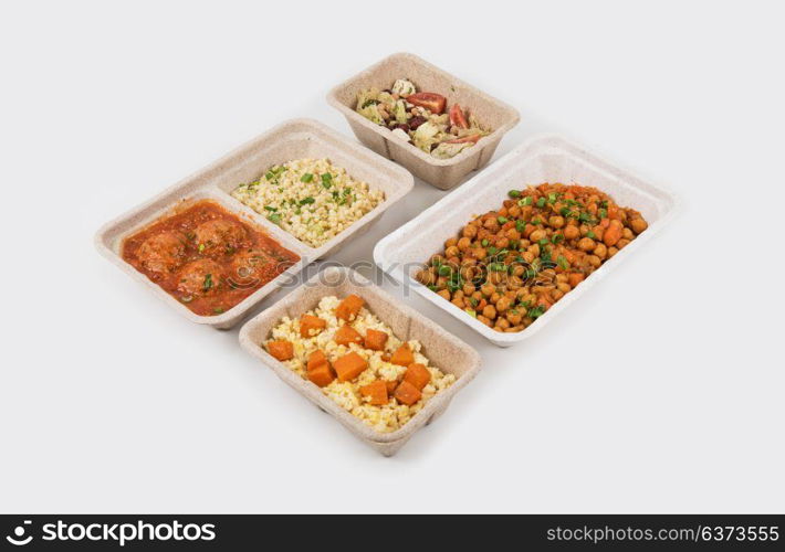 Healthy food delivery. Healthy food delivery for fitness nutrition or diet. Daily meals in paper boxes on a white background