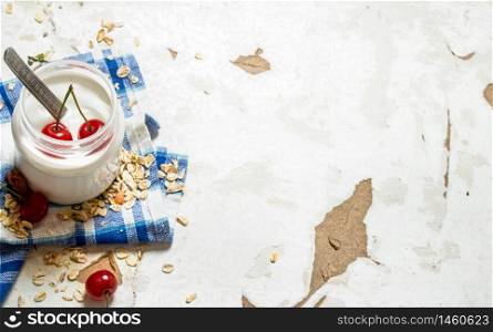 Healthy food . Dessert cereal and a ripe cherry. On rustic background.. Healthy food . Dessert cereal and a ripe cherry.