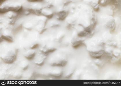 Healthy food, desserts dishes during diet, dairy products concept. Detailed closeup of white yoghurt with rise or cheese.. Detailed closeup of yoghurt with rise