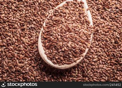 Healthy food diet. Closeup brown flax seeds linseed on wooden spoon