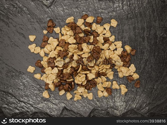 Healthy food: flakes chocolate and honey on a stone background.. Healthy food: flakes chocolate and honey on a stone background