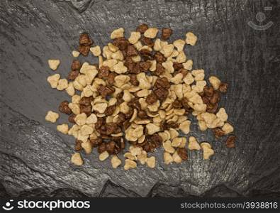 Healthy food: flakes chocolate and honey on a stone background.. Healthy food: flakes chocolate and honey on a stone background