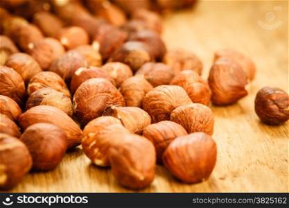 Healthy food full of fatty acids, organic nutrition. Hazelnuts kernel on rustic old wooden table