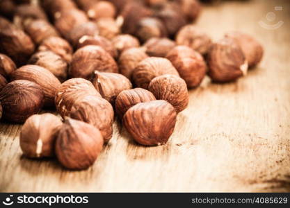 Healthy food full of fatty acids, organic nutrition. Hazelnuts kernel on rustic old wooden table