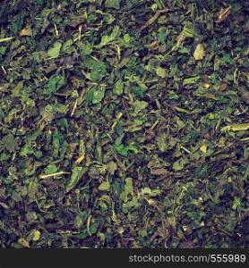 Healthy food, healing herbs, alternative herbal medicine concept. Food background of green dried nettle leaves. Food background herbal tea dried nettle leaves