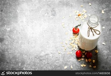 Healthy food . Milk with oats and berries. On the stone table.. Healthy food . Milk with oats and berries.