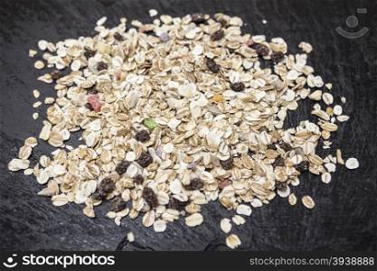 Healthy food: muesli with raisin and nuts on a stone background.. Healthy food: muesli with raisin and nuts on a stone background