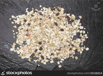 Healthy food: muesli with raisin and nuts on a stone background.. Healthy food: muesli with raisin and nuts on a stone background