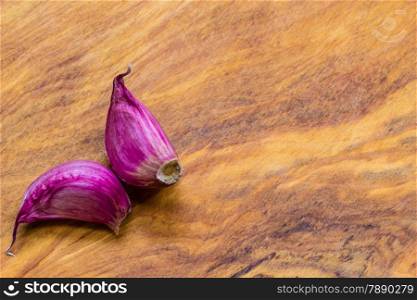 Healthy food. Organic garlic cloves on rustic wooden table background