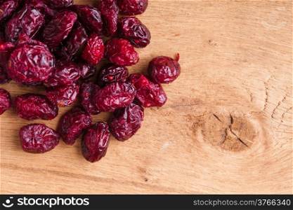Healthy food organic nutrition. Border frame of dried cranberries cranberry fruit on wooden background