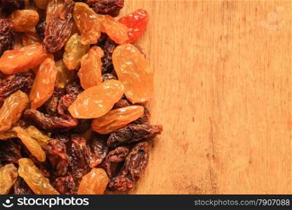 Healthy food organic nutrition. Border frame of raisin on wooden table background
