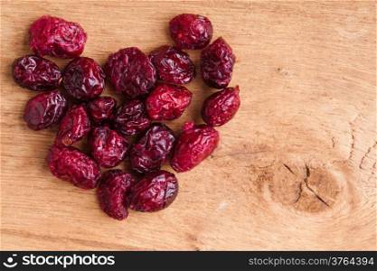 Healthy food organic nutrition. Heap of dried cranberries cranberry fruit on wooden table background