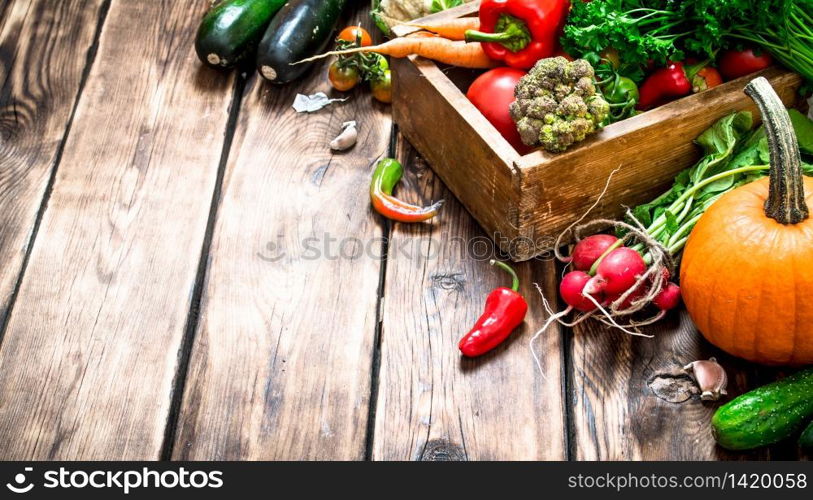 Healthy food. Organic vegetables in an old box. On wooden background.. Healthy food. Organic vegetables in an old box.