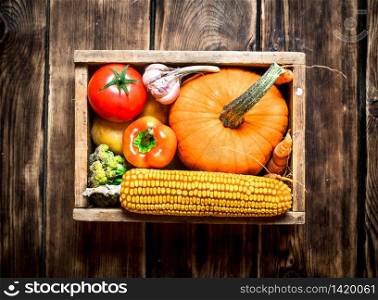 Healthy food. Organic vegetables in an old box. On wooden background.. Healthy food. Organic vegetables in an old box.